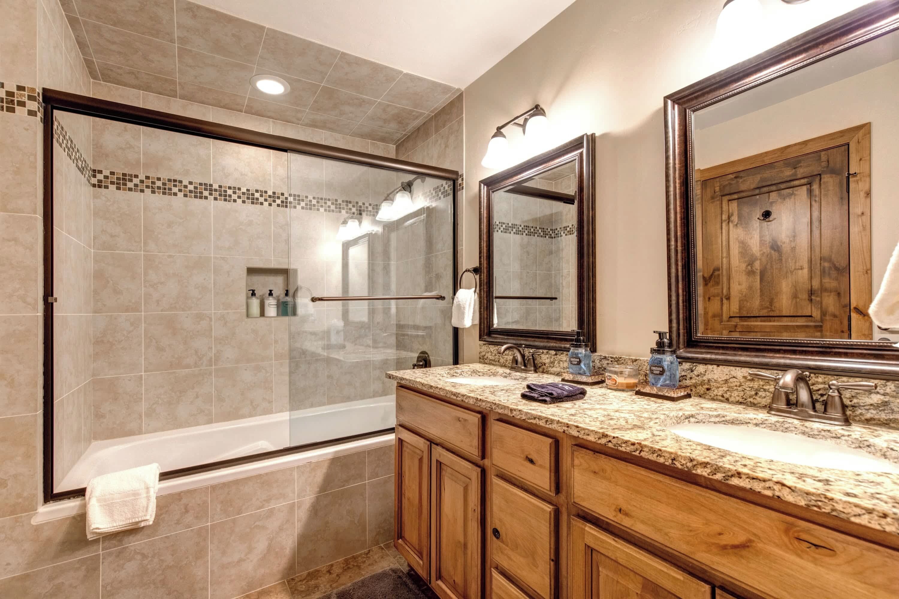 Bathtub, hair dryer, towels, shampoo