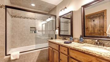 Bathtub, hair dryer, towels, shampoo