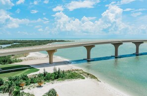 A bridge over a body of water with a clear sky.