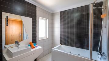 Combined shower/tub, hair dryer, towels, toilet paper