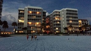 A modern hotel with multiple floors and balconies, featuring a beach view. - Crescent Arms Luxurious Gulf front Siesta Key Condo 604S (Siesta Key)