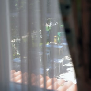 Guests can enjoy a casual outdoor seating area with tables and chairs.
