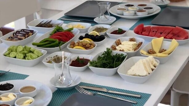 A table set with various food items and condiments, likely for a buffet or picnic. - NİLİA BOZCAADA (Bozcaada)