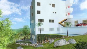 A modern multi-story building with a flat roof, a central staircase, and a parking area with a red car. - Style & Design Loft: 2 PRIVATE JACUZZIS, POOL, TERRACE, GRILL! (Cuernavaca)