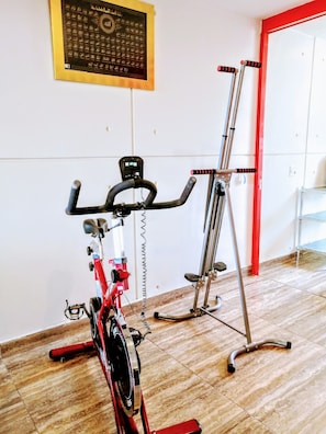 A gym with an exercise bike and a treadmill. - Style & Design Loft: 2 PRIVATE JACUZZIS, POOL, TERRACE, GRILL! (Cuernavaca)
