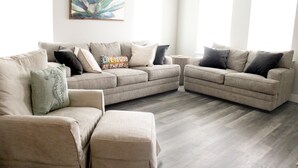 A living room with a sectional sofa, a chaise lounge, and a coffee table.