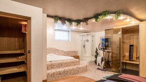 A spa room with a wooden bench, a massage table, a shower area, and a small staircase leading to a bed. - Holiday Apartment "3 - Ciasa Primula" (san Vigilio di Marebbe)