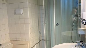 A bathroom with a glass shower enclosure, a white sink, and a toilet. - Cozy Studio Near Thermal Baths with Balcony, A/C, and Modern Amenities (Balaruc-les-Bains)