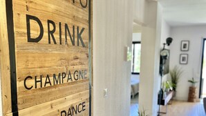 A wooden sign with the text "TIME TO DRINK CHAMPAGNE AND DANCE ON THE TABLE" in a hallway. - 51 - Apartment in Riviera walking distance to everything (Mijas Costa)