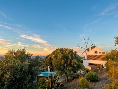 Charming windmill between nature and sea
