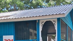 A blue building with a white door and a number '201' sign. - MONTHLY RENTAL, KING BED, HOT TUB, WIFI, KITCHEN, KENNARD TX. 159 HWY 7 #201 (Kennard)