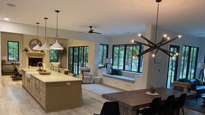 A spacious kitchen with a large island, pendant lighting, and a built-in fireplace. - Lake Hartwell water front with private dock, sleeps 15 (Hartwell)