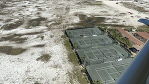 Blick auf die Küste mit Tennisplatz und Strand.