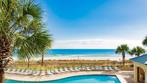 A pool area with lounge chairs and a view of the beach. - High Speed Wi-fi, Corner Unit w/Beach and Pool Views (Orange Beach)
