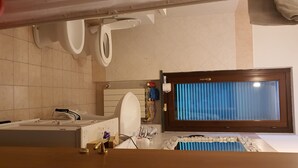 A bathroom with a bathtub, toilet, and sink.