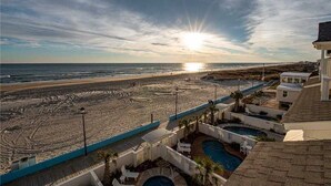 A beach resort with a pool area, a view of the ocean, and a sunset. - Ocean Front Ocean View, With Private Heated Pool & Hot Tub (Atlantic Beach)