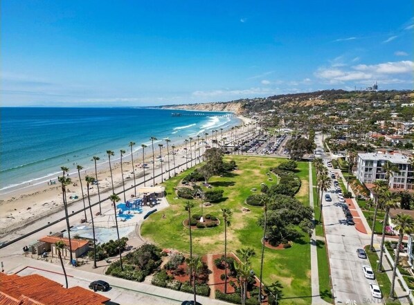 Enjoy a leisurely stroll along the beachfront promenade, lined with palm trees and beach umbrellas.