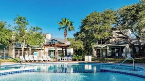 A swimming pool with lounge chairs and a covered seating area. - The Sand Piper-Pier, Pool, Bay View & Boat Launch (Rockport)