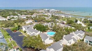 A residential area with houses, a swimming pool, and a view of the ocean. - The Sand Piper-Pier, Pool, Bay View & Boat Launch (Rockport)