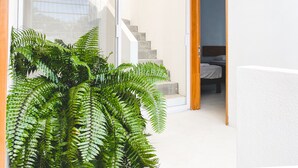 A modern interior with a staircase leading to a bedroom.