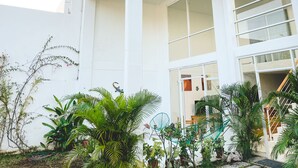 A modern building with large windows and a balcony.