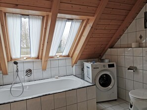 Bathtub, hair dryer, towels, soap