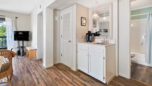 A modern bathroom with a shower, toilet, and sink.