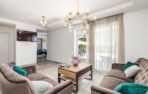 Relax in this inviting living space with a sofa, coffee table, and dining area.