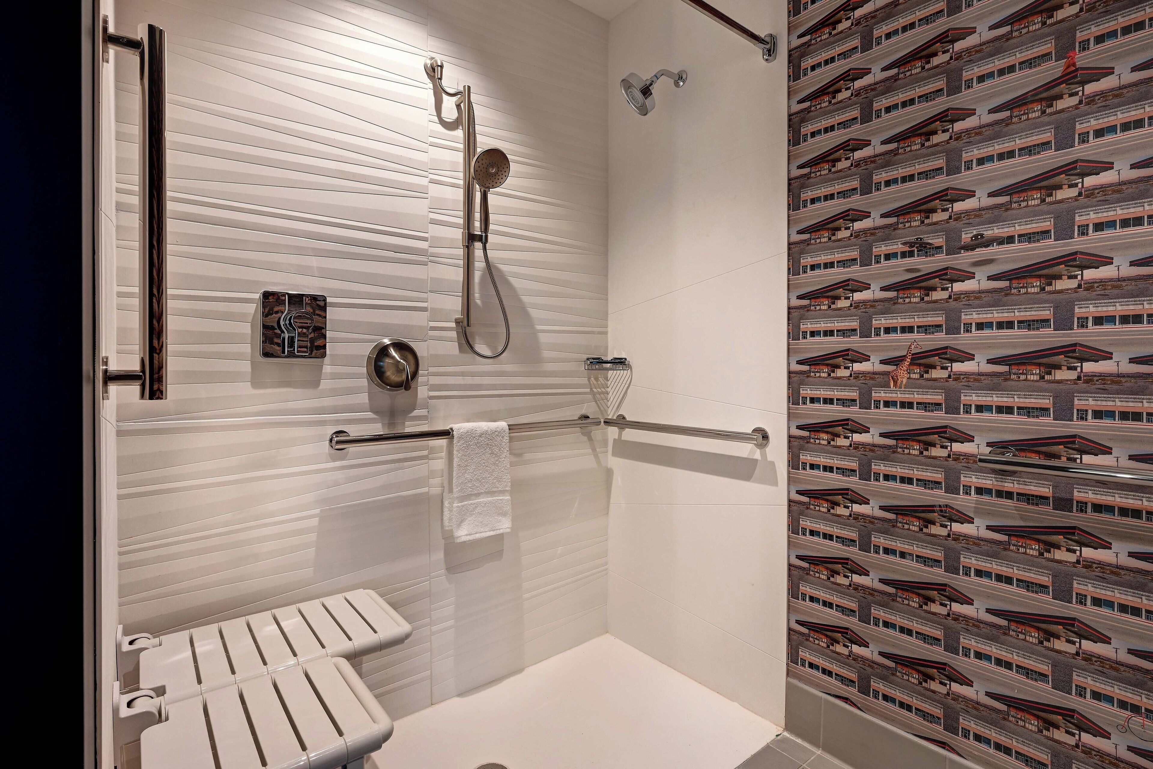 A modern bathroom with a walk-in shower, a towel rack, and a toilet.