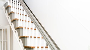 A staircase with white railings and wooden steps. - Historic 1880 Farmhouse with Modern Southern Charm (Casar)