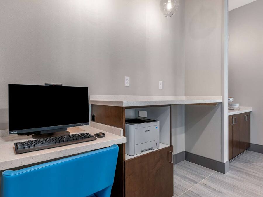 A modern kitchen with a built-in microwave, a coffee maker, and a sink.