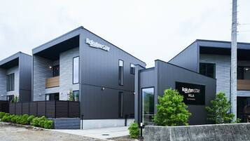 A modern building with a sign reading "Rakuten Stay Villa."