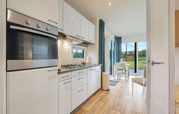 Fridge, stovetop, dishwasher, coffee/tea maker