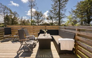 Relax on the outdoor patio with a bench, lounge chairs, and a small table.