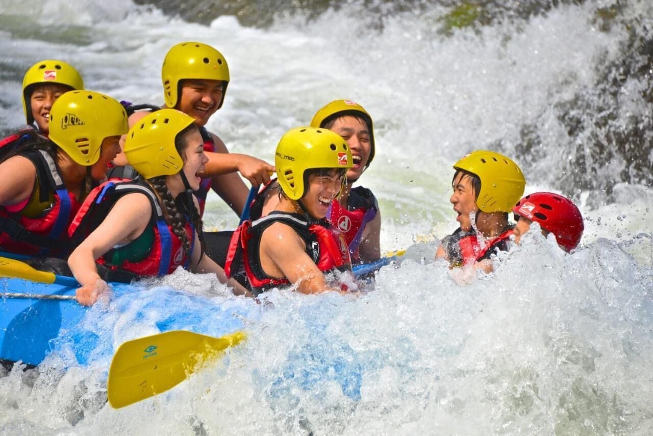 A group of people in a raft navigating a river.