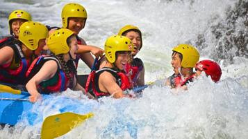 A group of people in a raft navigating a river.