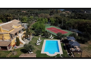 A residential property with a swimming pool, tennis court, and a landscaped garden. - Vip Luxury Villa Privilege Classic (Corfu)