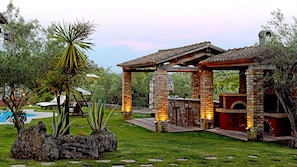 A patio area with a brick barbecue, stone pillars, and a pergola. - Villa Privilege Exclusive Private Luxury Retreat in Corfu (Corfu)
