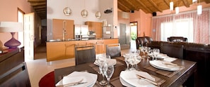 Enjoy meals in a comfortable dining area with a long table and leather seating.