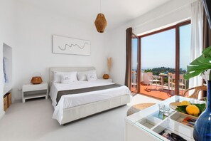 A modern bedroom with a large bed, a bedside table, a glass coffee table, and a view of the outdoors. - Villa Marianna Like Paradise in Amalfi Coast!!! (Massa Lubrense)