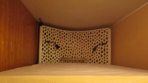 A small, single-bed room with a wooden headboard and a decorative white panel. - House Between Etna and the sea Near Taormina (Santa Venerina)