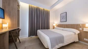 Relax in a stylish room with a comfortable bed, desk, and flat-screen TV.