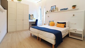 A bedroom with a bed, bedside table, nightstand, wardrobe, and a desk with a chair. - La Terrazza Family Holidays Your Dream Getaway in Sorrento Coast (Sant'Agnello)