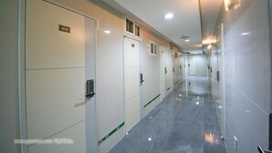 Un largo y estrecho pasillo con puertas numeradas 316, 317 y 318, que conducen a habitaciones individuales.