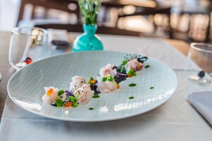 A plate of food with a decorative vase in the background.