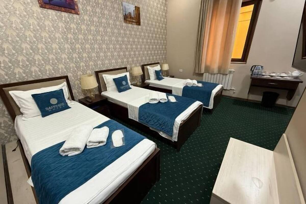 Premium bedding, desk, laptop workspace, blackout drapes