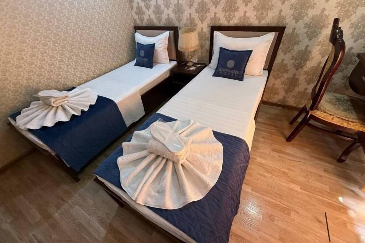 Premium bedding, desk, laptop workspace, blackout drapes