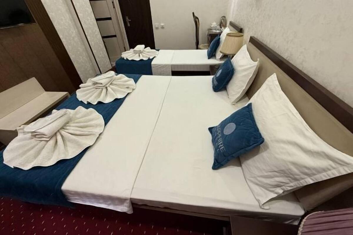 Premium bedding, desk, laptop workspace, blackout drapes