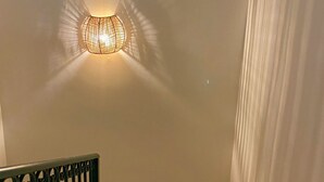 A wall-mounted light fixture with a circular design casting a warm glow. - Semiramis 7 - Altea, Costa Blanca (Altea)