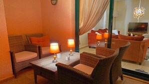 A cozy living area with wicker furniture, two lamps, and a television. - Semiramis 7 - Altea, Costa Blanca (Altea)